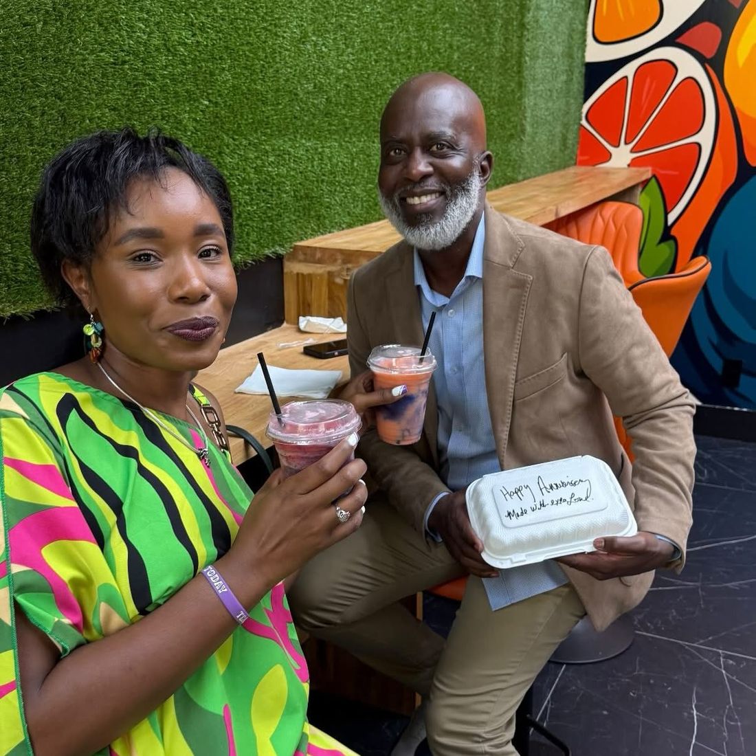 A couple celebrating an anniversary with Smooth N Groove drinks at the mural