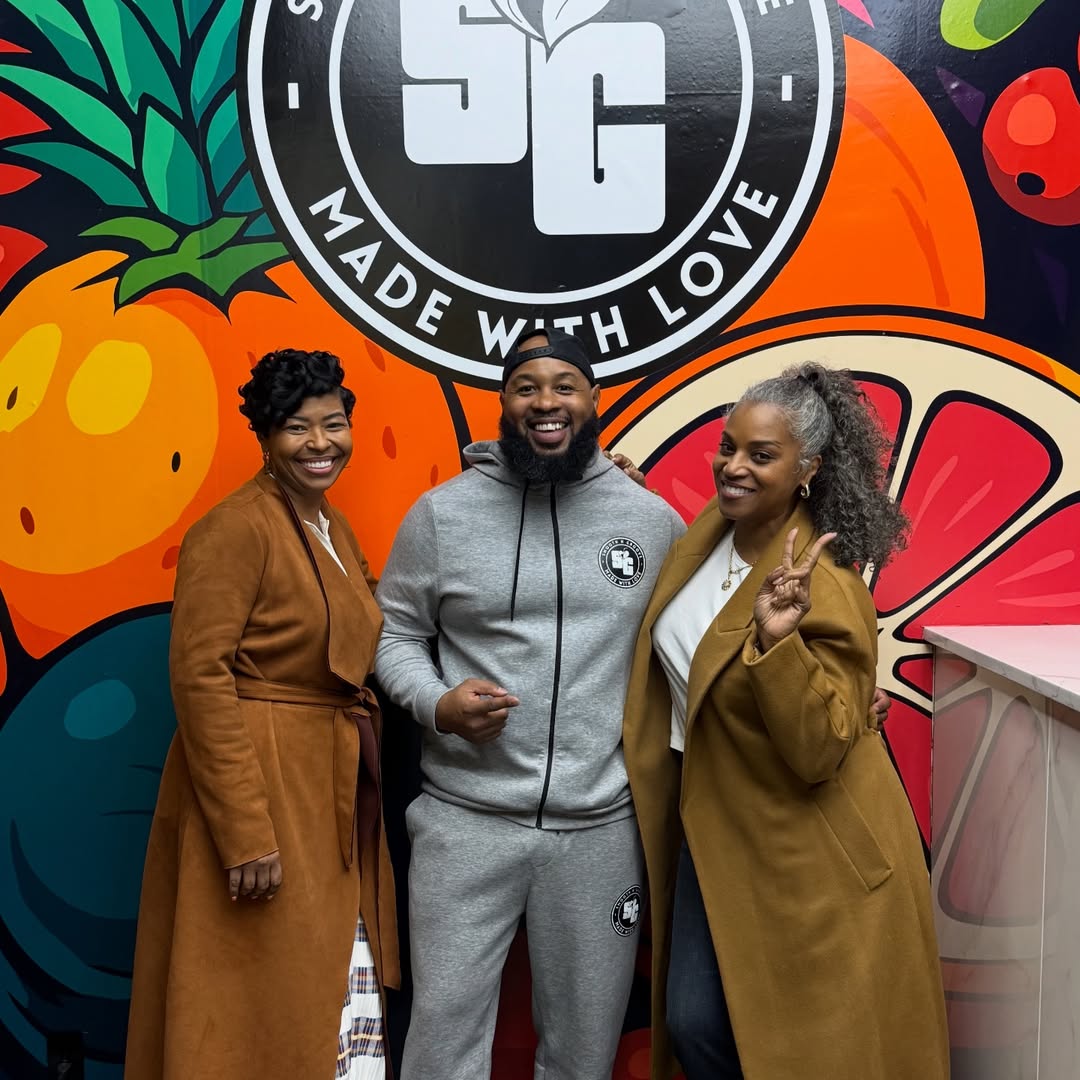 Keon Davis with two guests in front of the Smooth N Groove mural